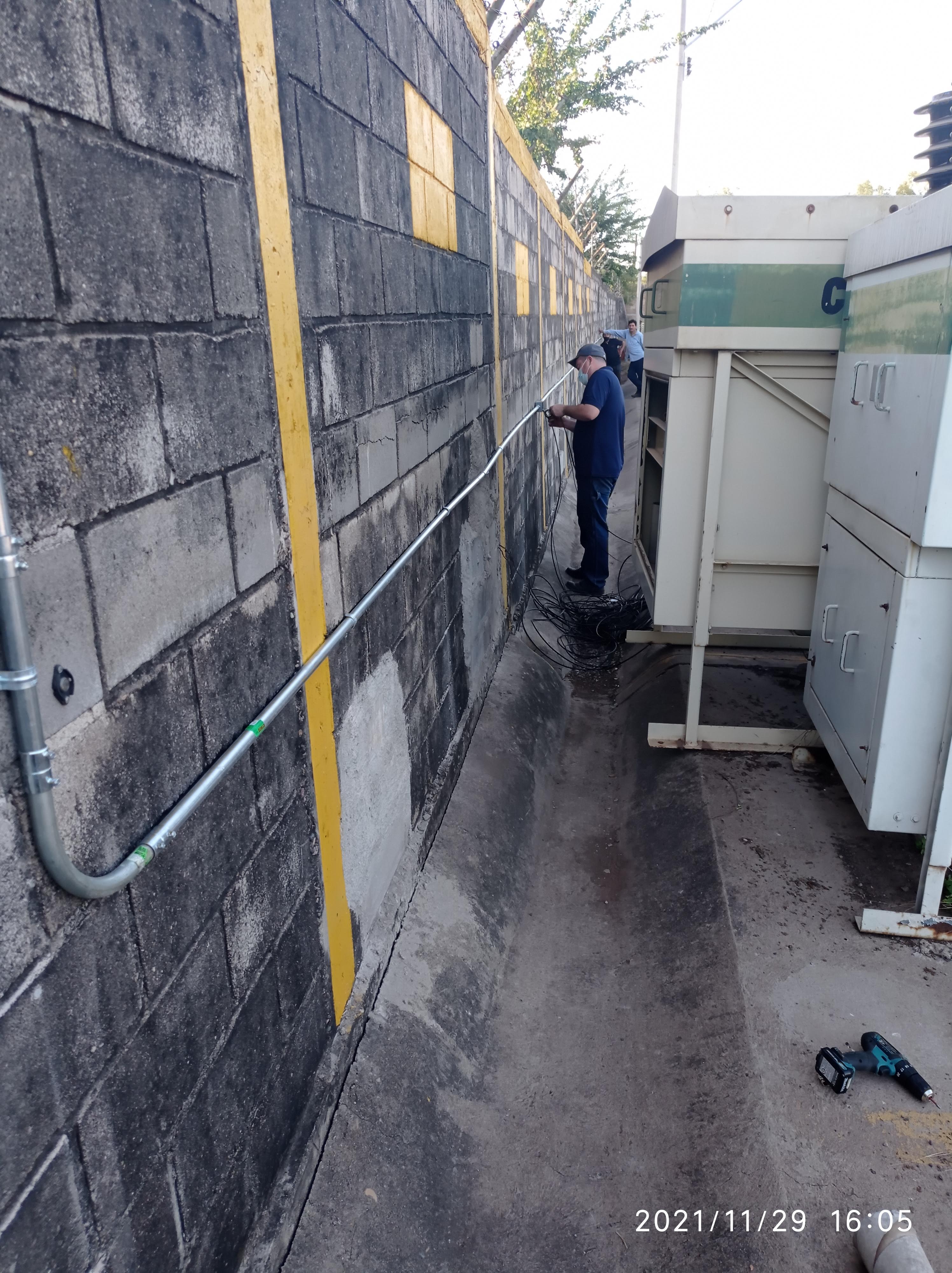 Técnico tendiendo cableado hacia tablero eléctrico industrial